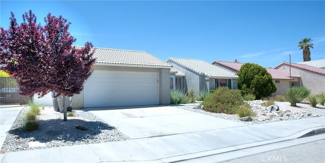 5538 Katrina Pl, Palmdale, CA 93552 - ranch-style house featuring a garage, a tiled roof, stucco siding, and concrete driveway