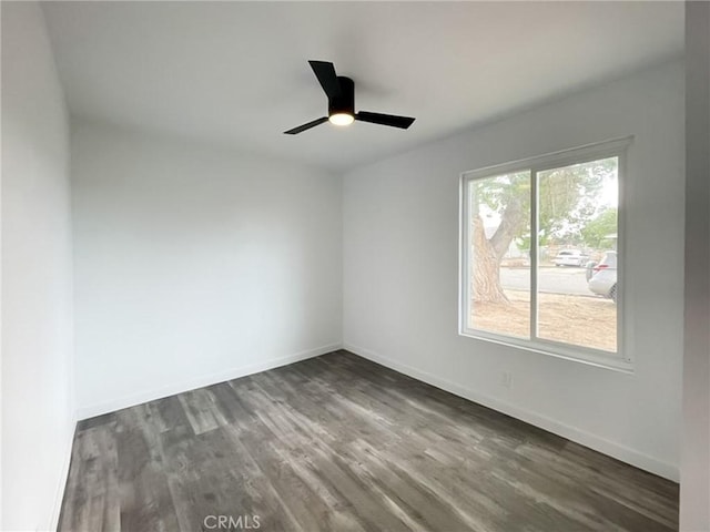 unfurnished room with wood finished floors, ceiling fan, and baseboards