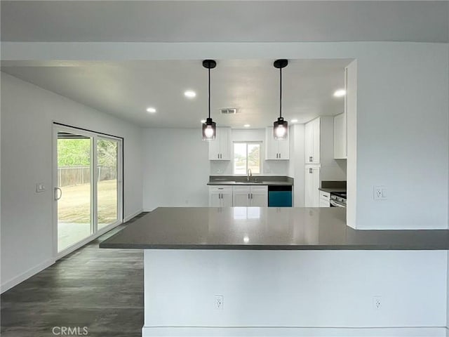 kitchen featuring dark countertops, white cabinetry, dishwashing machine, dark wood-style flooring, and recessed lighting