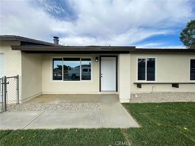 entrance to property featuring stucco siding