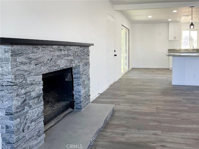 40294 Fieldspring St, Palmdale, CA 93591 - unfurnished living room with wood finished floors, recessed lighting, and a stone fireplace