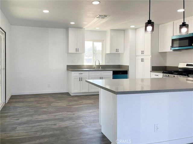 40294 Fieldspring St, Palmdale, CA 93591 - kitchen with appliances with stainless steel finishes, white cabinets, recessed lighting, and dark wood-type flooring