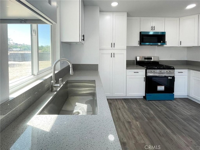 40294 Fieldspring St, Palmdale, CA 93591 - kitchen with appliances with stainless steel finishes, white cabinetry, recessed lighting, and dark wood-style flooring