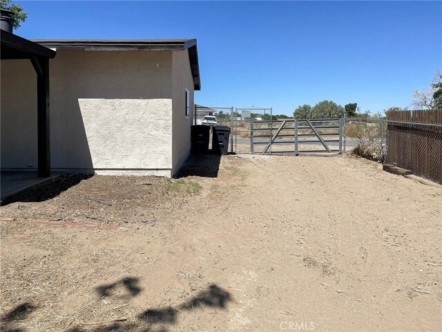 40294 Fieldspring St, Palmdale, CA 93591 - view of property exterior with a gate and stucco siding