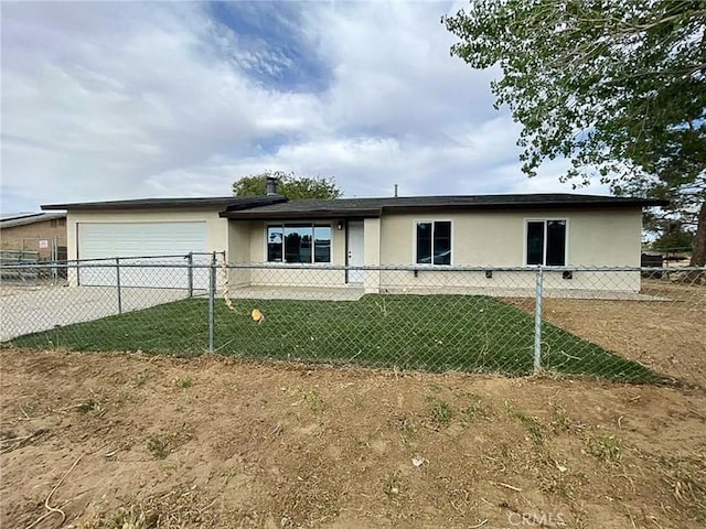 single story home featuring stucco siding, an attached garage, and driveway