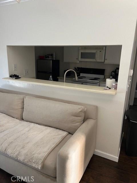 living room with dark wood finished floors and baseboards