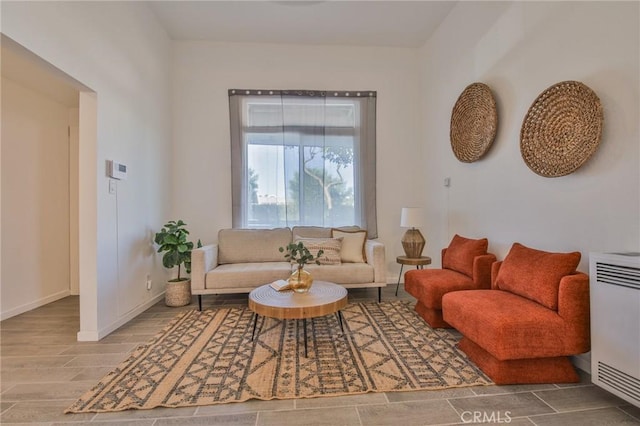 living area with wood finished floors and baseboards