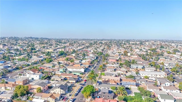 aerial view of property and surrounding area with nearby suburban area