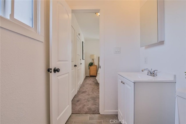 bathroom featuring vanity and baseboards