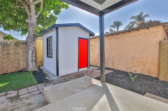 view of shed featuring fence