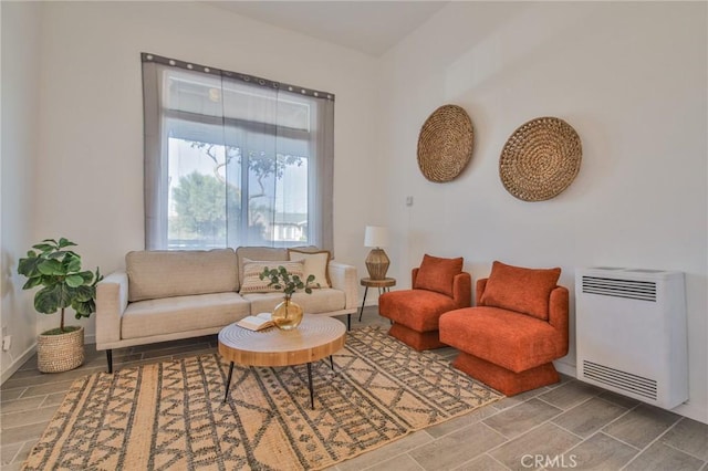 living room with heating unit and baseboards
