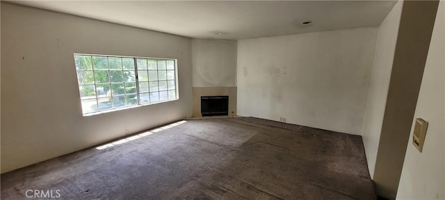 unfurnished living room featuring carpet floors and a fireplace