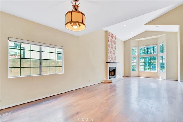 14807 Otsego St, Sherman Oaks, CA 91403 - unfurnished living room featuring a large fireplace, wood finished floors, high vaulted ceiling, and baseboards