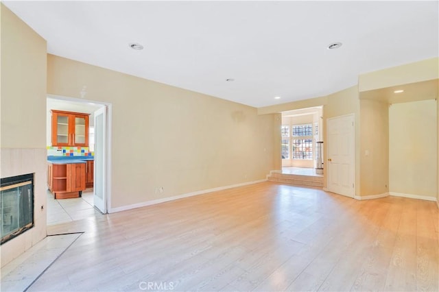 14807 Otsego St, Sherman Oaks, CA 91403 - unfurnished living room featuring light wood finished floors, a tiled fireplace, baseboards, and recessed lighting
