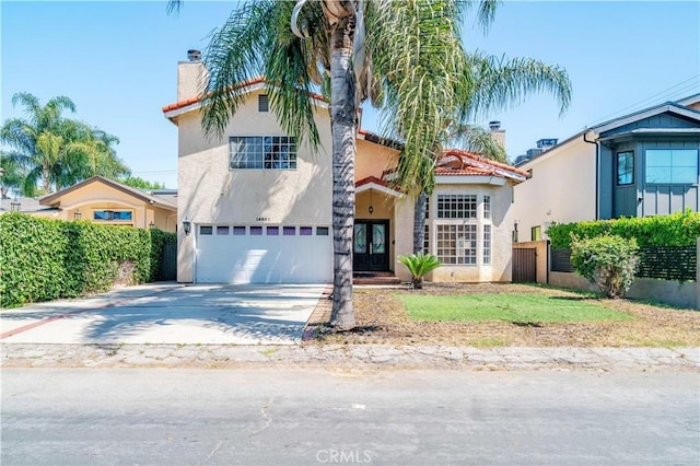14807 Otsego St, Sherman Oaks, CA 91403 - mediterranean / spanish-style home featuring an attached garage, stucco siding, fence, and concrete driveway
