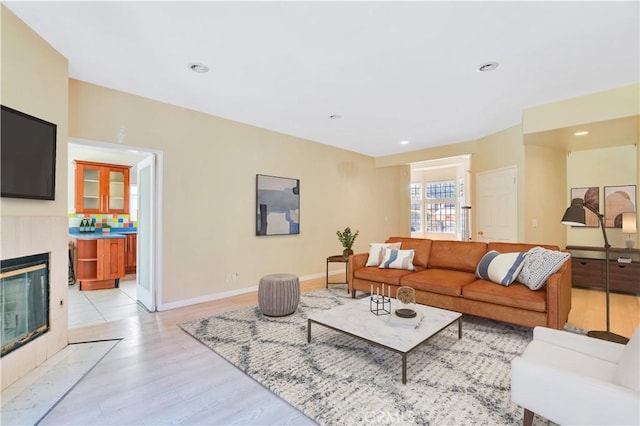 14807 Otsego St, Sherman Oaks, CA 91403 - living area with light wood-style floors, a tiled fireplace, recessed lighting, and baseboards
