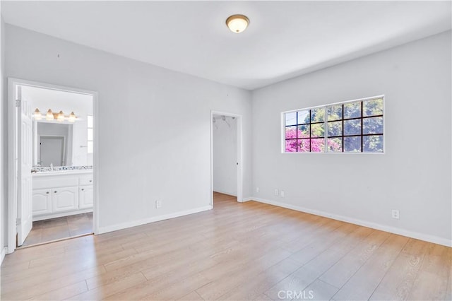 14807 Otsego St, Sherman Oaks, CA 91403 - unfurnished bedroom featuring light wood finished floors, a walk in closet, baseboards, and connected bathroom