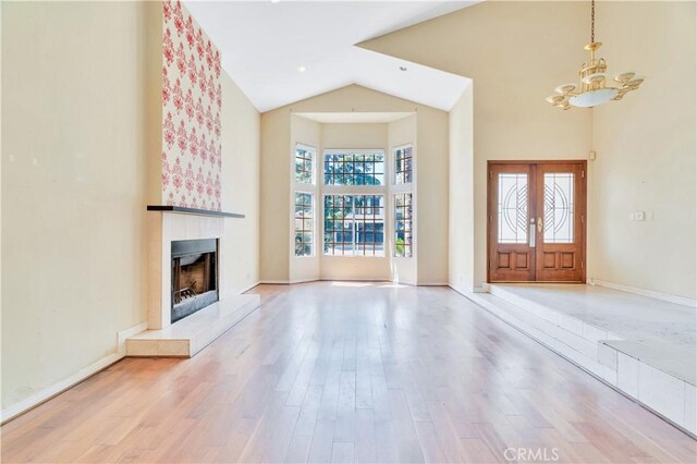 14807 Otsego St, Sherman Oaks, CA 91403 - entrance foyer with a chandelier, a fireplace with raised hearth, high vaulted ceiling, wood finished floors, and baseboards