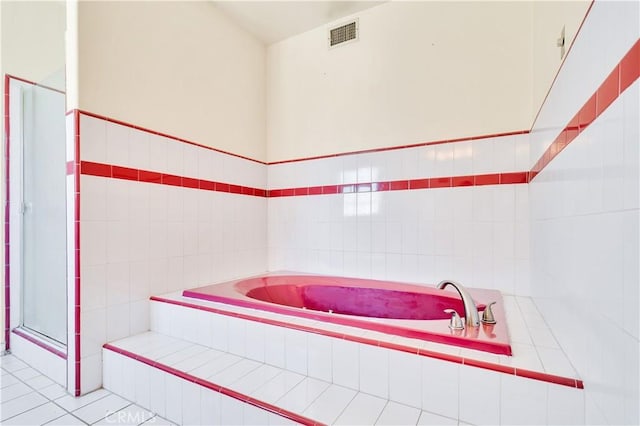 14807 Otsego St, Sherman Oaks, CA 91403 - full bath featuring a stall shower, tile patterned floors, a garden tub, and tile walls