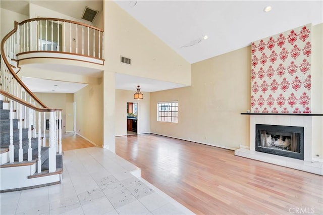 14807 Otsego St, Sherman Oaks, CA 91403 - unfurnished living room featuring a fireplace, high vaulted ceiling, wood finished floors, stairway, and baseboards