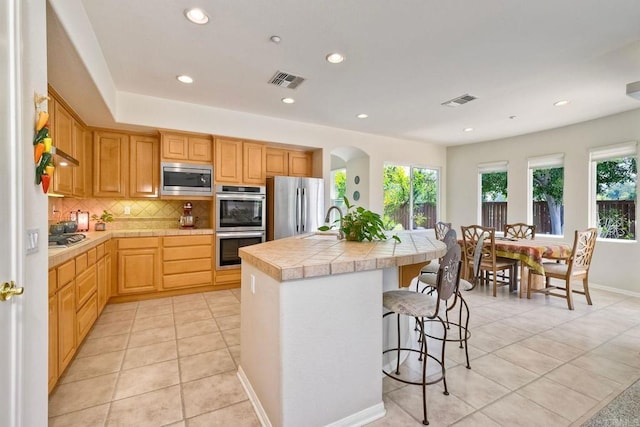 1752 Russet Leaf Ct, El Cajon, CA 92019 - kitchen with appliances with stainless steel finishes, tasteful backsplash, a sink, recessed lighting, and a center island with sink