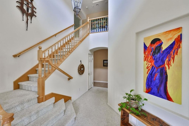1752 Russet Leaf Ct, El Cajon, CA 92019 - stairs featuring arched walkways, carpet, baseboards, and a high ceiling