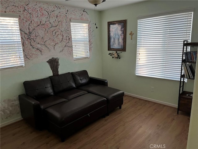 living room featuring baseboards and wood finished floors