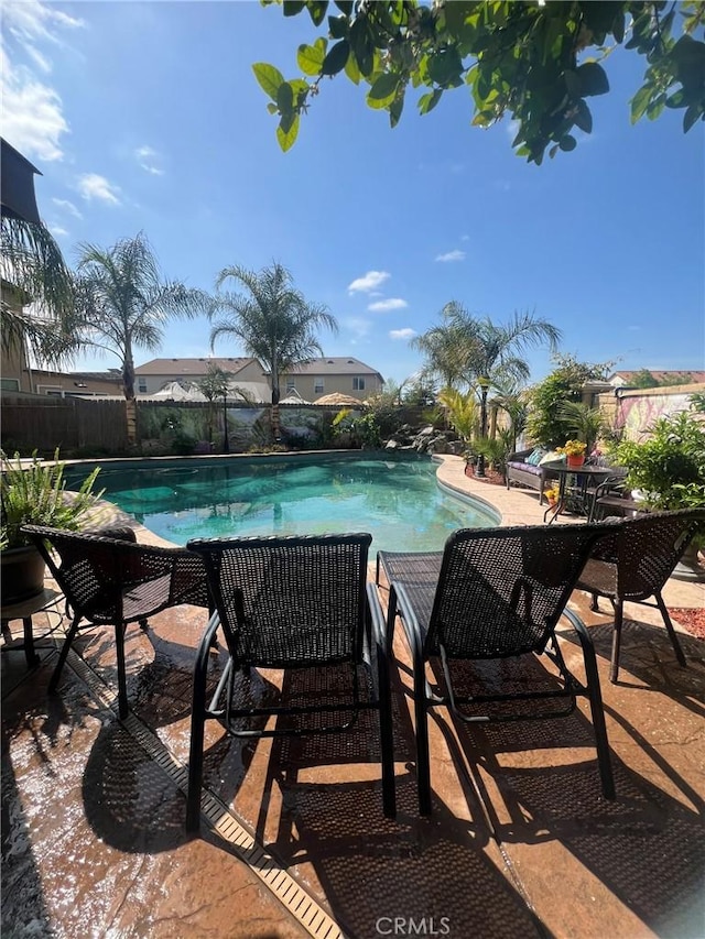 view of pool with fence and a patio area