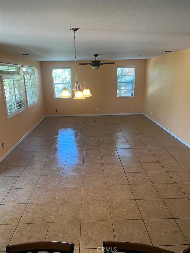 unfurnished room with tile patterned flooring, baseboards, ceiling fan, and a textured ceiling