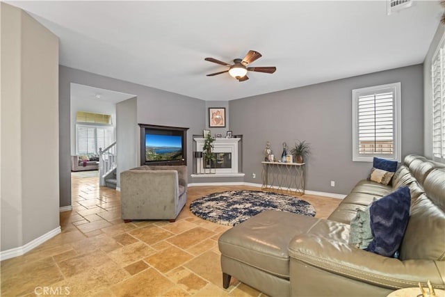 34274 Deergrass Way, Lake Elsinore, CA 92532 - living area with a ceiling fan, baseboards, stairs, and stone tile floors