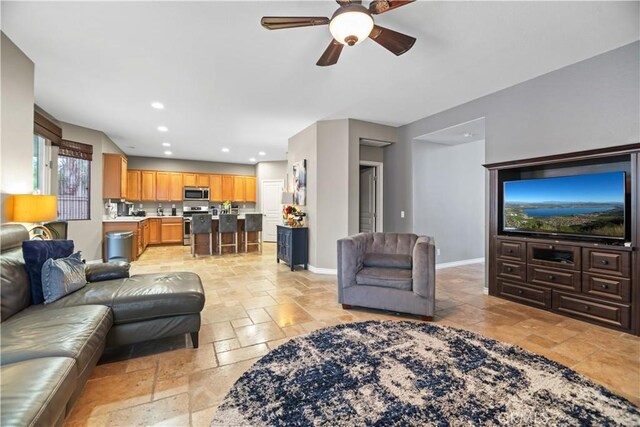 34274 Deergrass Way, Lake Elsinore, CA 92532 - living room featuring stone tile floors, a ceiling fan, baseboards, and recessed lighting