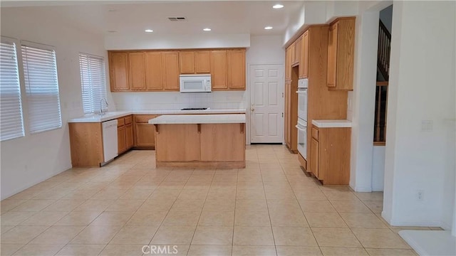 29746 Maxmillian Ave, Murrieta, CA 92563 - kitchen featuring white appliances, light countertops, a kitchen island, light tile patterned floors, and recessed lighting
