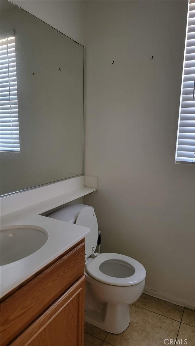 29746 Maxmillian Ave, Murrieta, CA 92563 - half bathroom featuring tile patterned flooring, toilet, and vanity