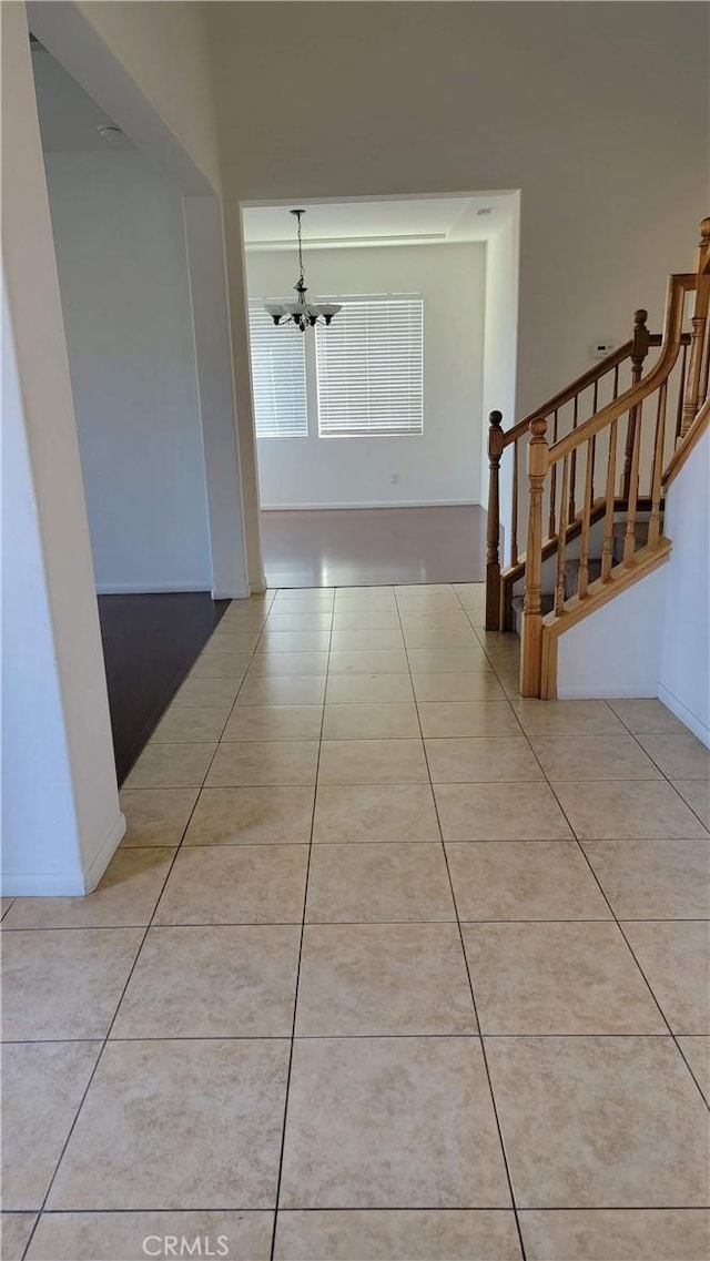 29746 Maxmillian Ave, Murrieta, CA 92563 - corridor with a chandelier, light tile patterned flooring, stairway, and baseboards