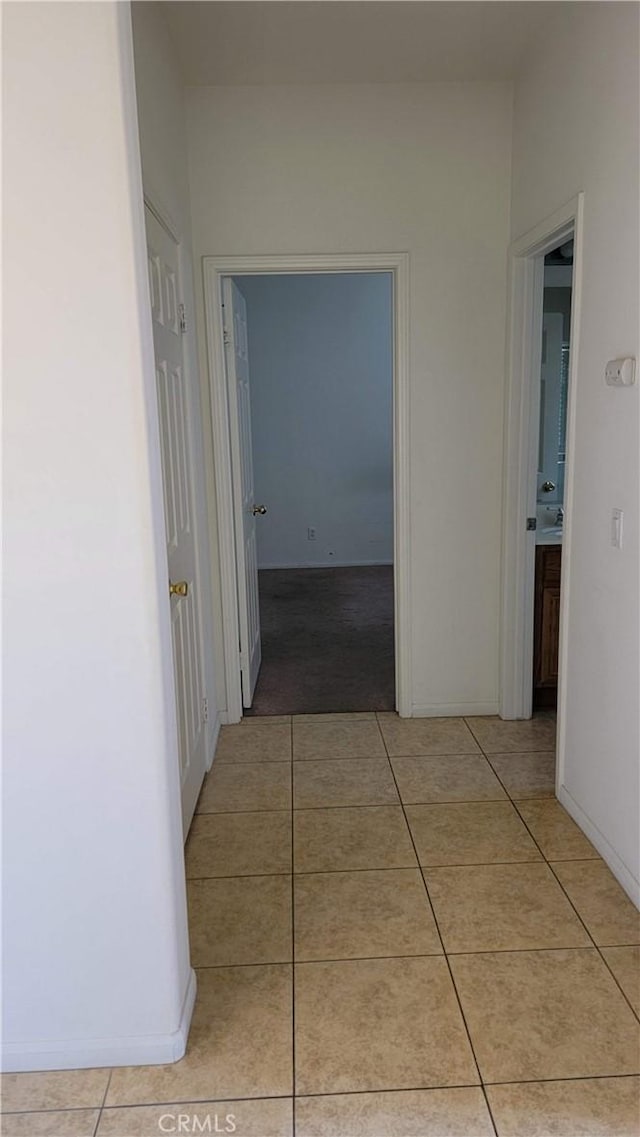 29746 Maxmillian Ave, Murrieta, CA 92563 - hallway featuring light tile patterned floors and baseboards