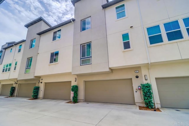 2140 Stellar Way Unit 4, Chula Vista, CA 91915 - rear view of property with a garage and stucco siding