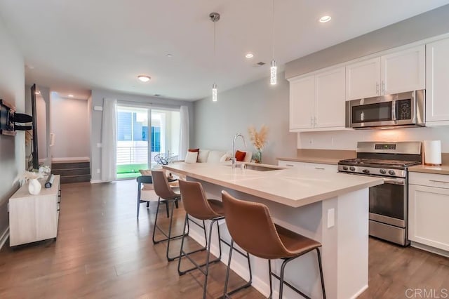 2140 Stellar Way Unit 4, Chula Vista, CA 91915 - kitchen featuring appliances with stainless steel finishes, wood finished floors, white cabinets, light countertops, and recessed lighting