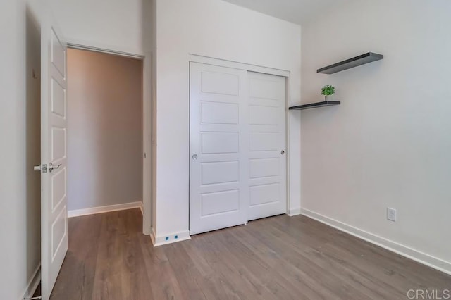 2140 Stellar Way Unit 4, Chula Vista, CA 91915 - unfurnished bedroom featuring wood finished floors and a closet