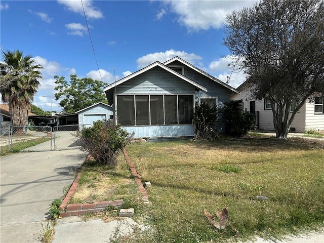 7423 Indiana Ave, Riverside, CA 92504 - view of front facade featuring a sunroom, concrete driveway, and a gate