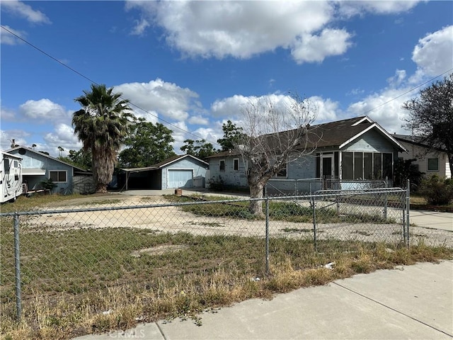 7423 Indiana Ave, Riverside, CA 92504 - ranch-style house with driveway, a fenced front yard, a carport, and a detached garage