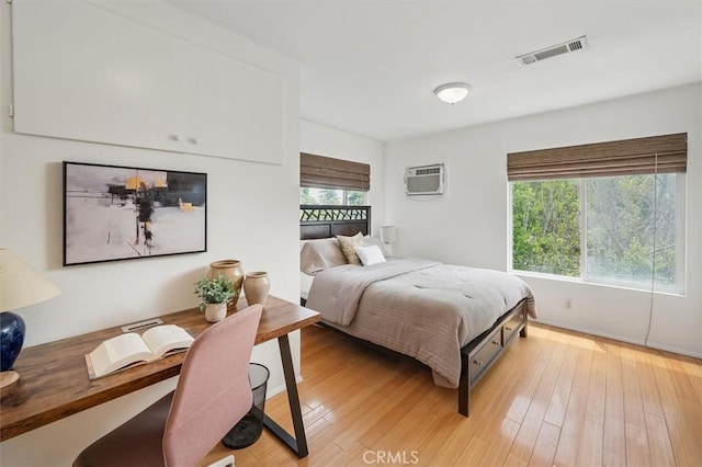 850 N Naomi St, Burbank, CA 91505 - bedroom featuring a wall mounted AC, light wood-style floors, and a desk