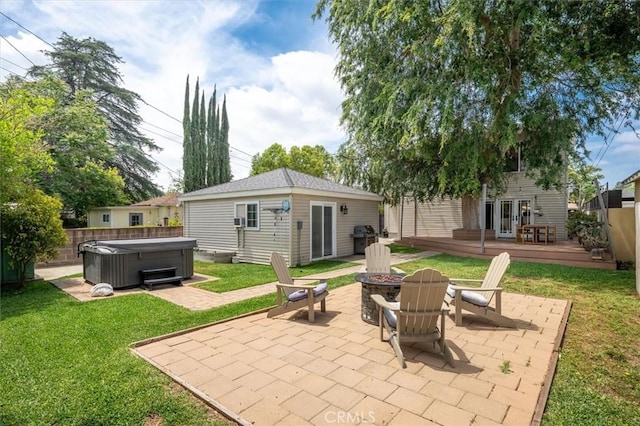 850 N Naomi St, Burbank, CA 91505 - rear view of house with a hot tub, a fire pit, a wooden deck, a patio, and an outdoor structure