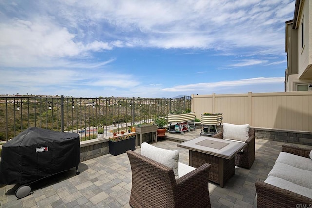 view of patio featuring area for grilling and fence