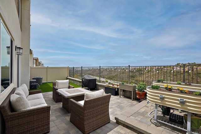 view of patio / terrace with an outdoor living space, a fenced backyard, and a grill