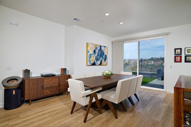 dining area featuring light wood finished floors, recessed lighting, and baseboards