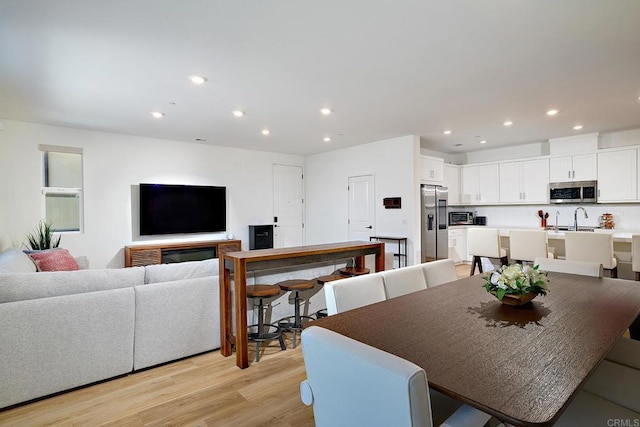 dining area with recessed lighting and light wood-type flooring