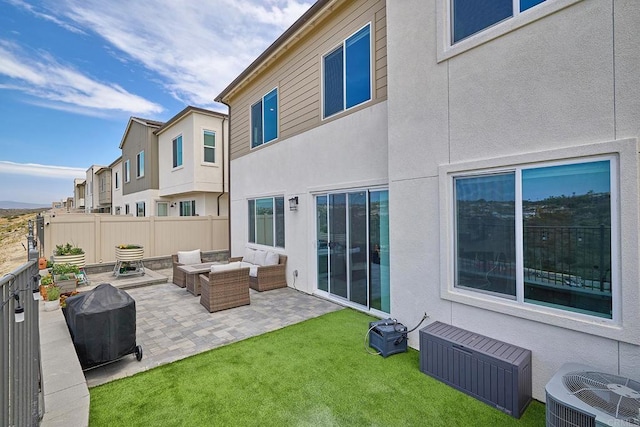 rear view of property featuring outdoor lounge area, central AC unit, a patio area, and stucco siding