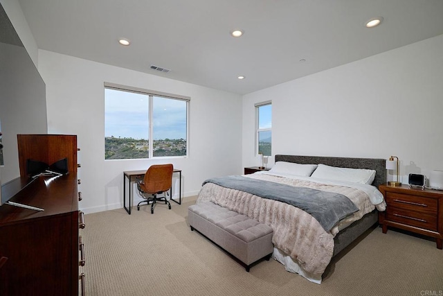 bedroom with light colored carpet, recessed lighting, a desk, and baseboards