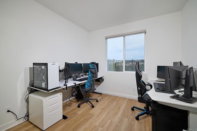 office space with light wood-style flooring and baseboards