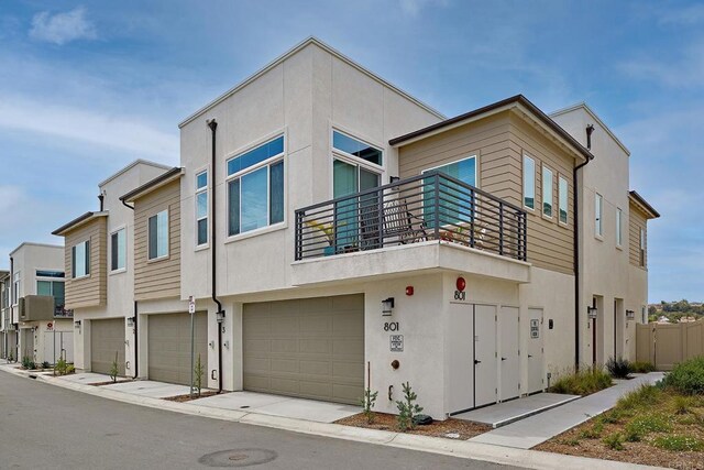 801 Mateo St Unit 2, Chula Vista, CA 91911 - view of front of house with a balcony, stucco siding, and a garage